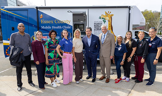 RWJBarnabas Health President and CEO Mark E. Manigan and group in front of the new Pediatric Mobile Health Van